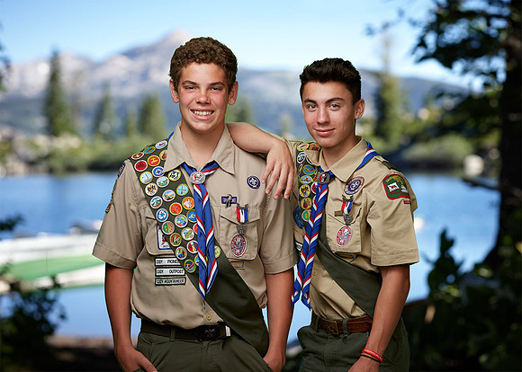 Environmental portrait of two eagle scouts in front of camp cody lake.