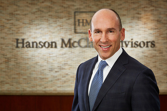 Professional Business Headshot of an executive at an office. Smiling.
