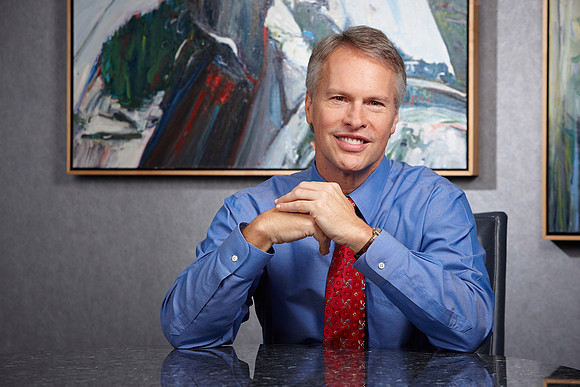 Business headshots of Gary Pruitt, a male executive in an office environment. Smiling at the camera.