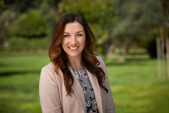 Photograph of a young female executive in Capital city park.