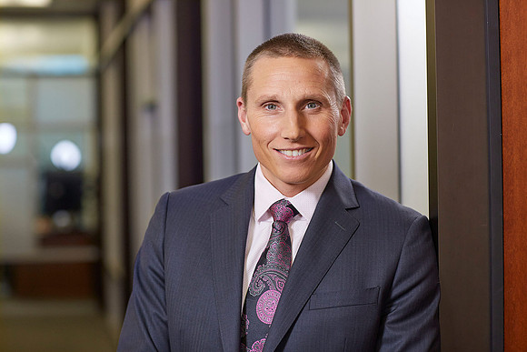 Business Headshot of executive smiling at camera in an office setting